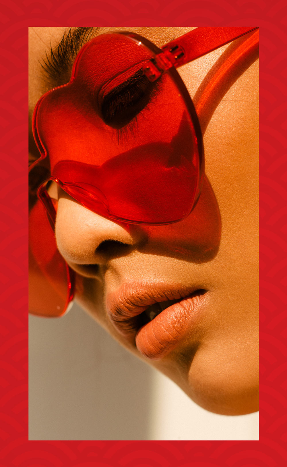 Photo of girl wearing red sunglasses, on red textured background