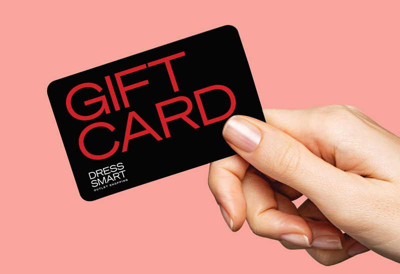 A hand holding a Dress Smart Gift Card